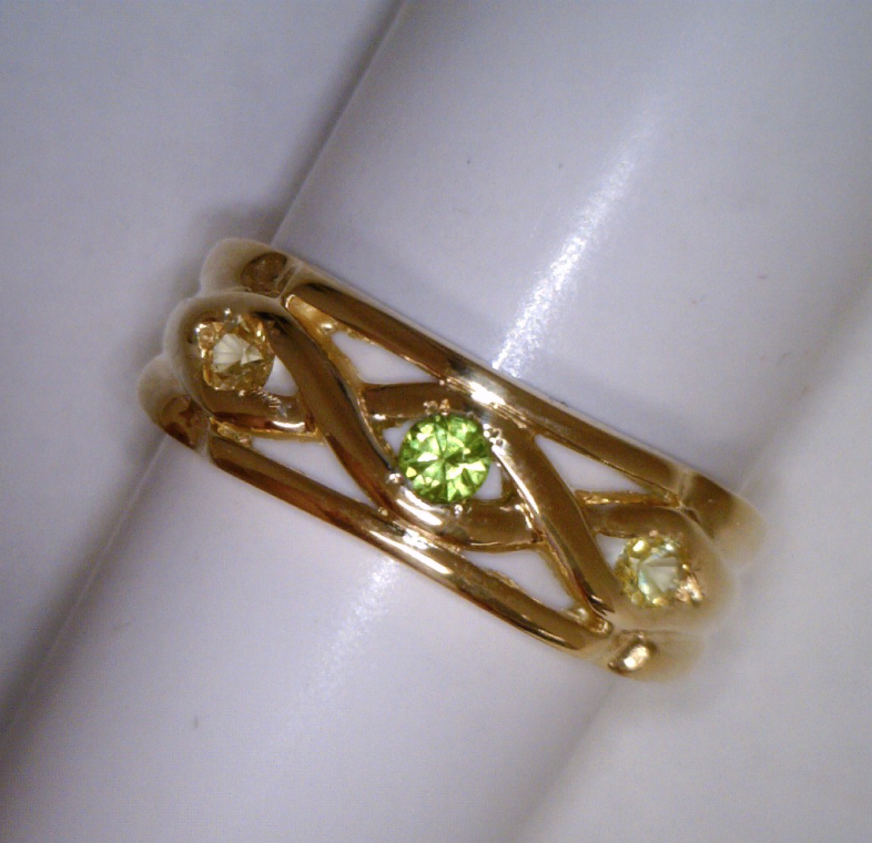 Gold ring with green gemstones